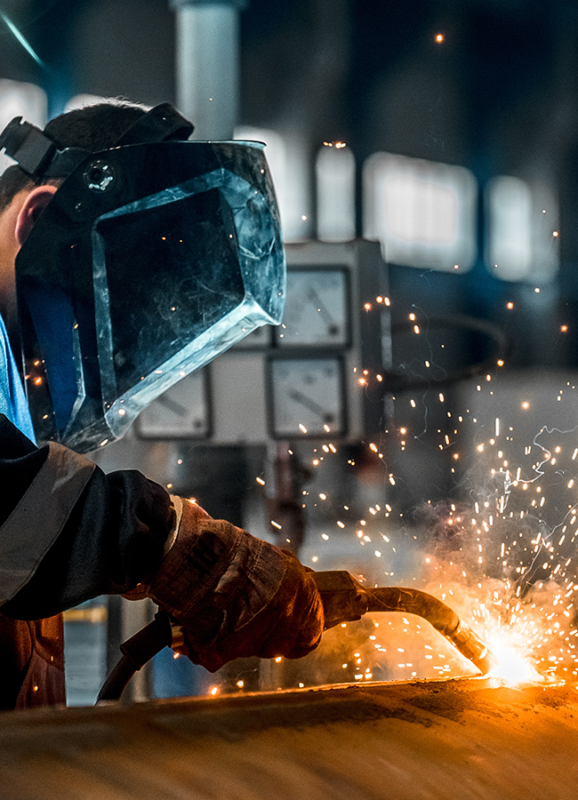 man welds at the factory